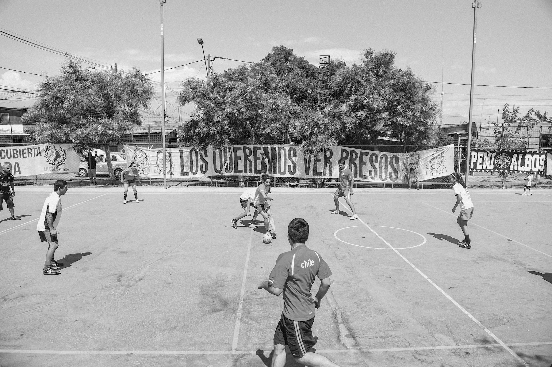  A game of pick-up fútbol during an event honoring political prisoners in La Victoria, Chile, a settlement in Santiago with a rooted history in organized urban land occupations. La Victoria is one of the first organized urban occupations of land in a