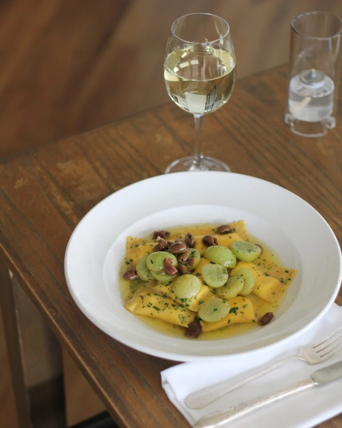 A ricotta-stuffed pasta with a surprise pairing: green grapes and Kalamata olives. At the staff menu tasting, this was one of our hands-down faves.