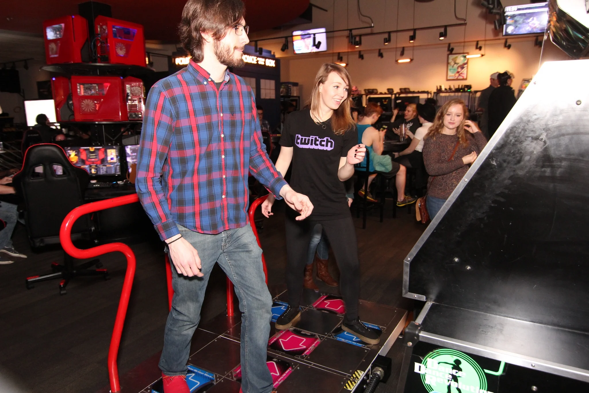 A woman and man play the dance-dance revolution game