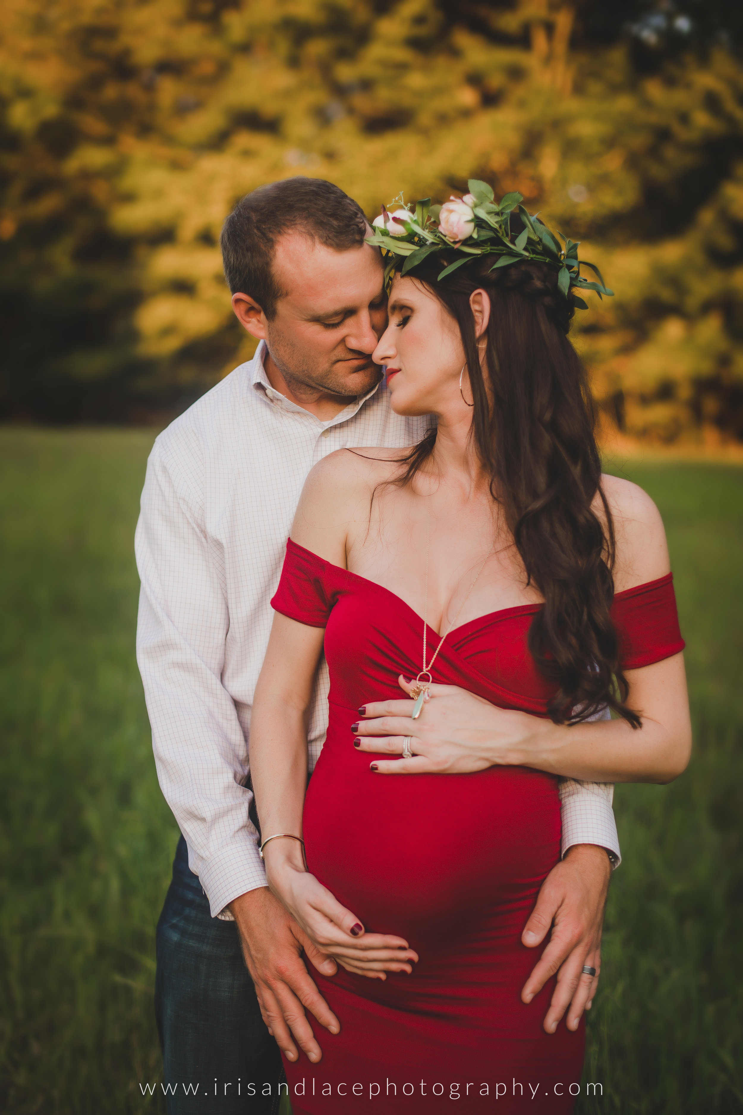 Couple holding pregnant belly