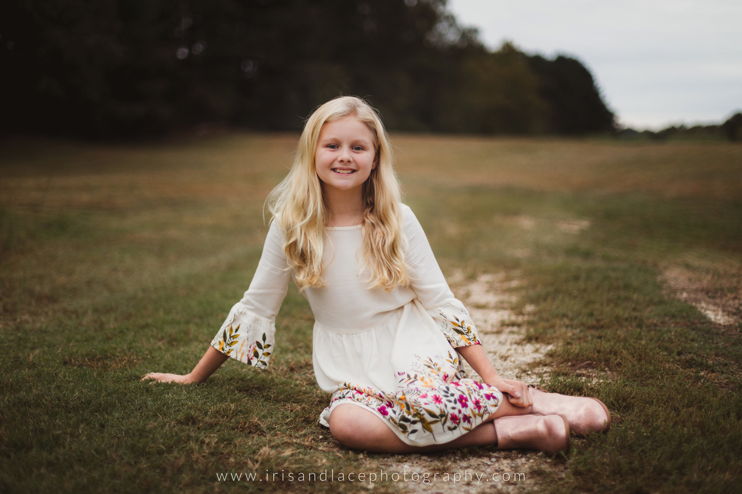 pre teen daughter sitting and smiling outdoors natural 