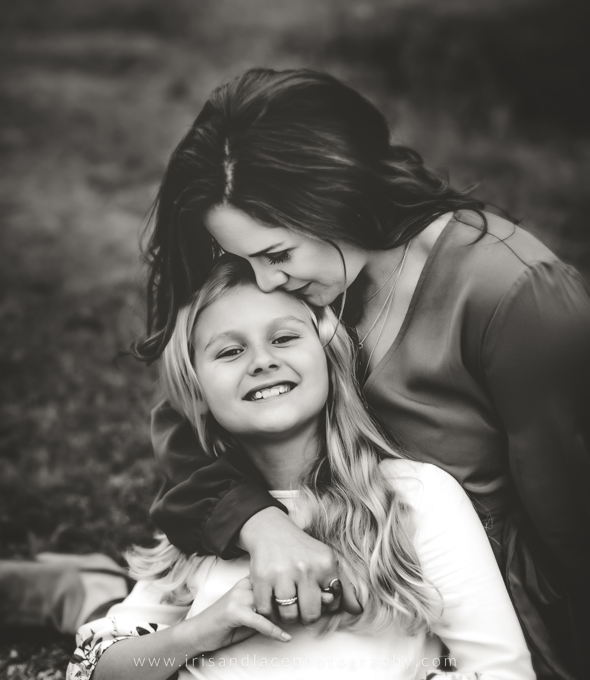 Black and white image of mother and daughter snuggling