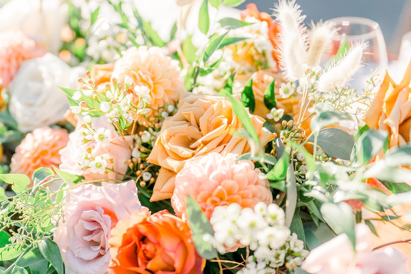 Close up of peach and coral roses in the centerpieces