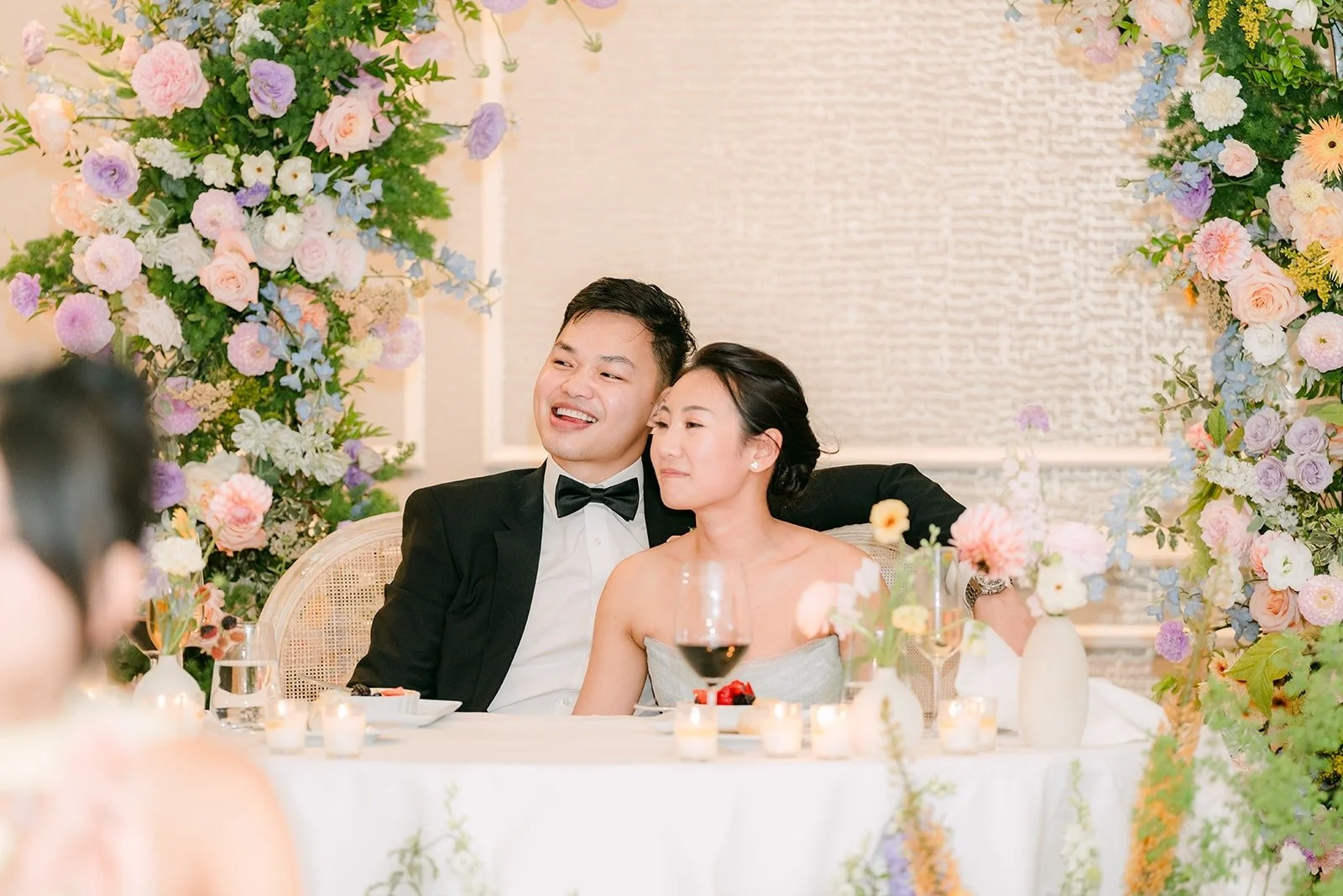 Kylie and Mario laughing at the sweetheart table during the games