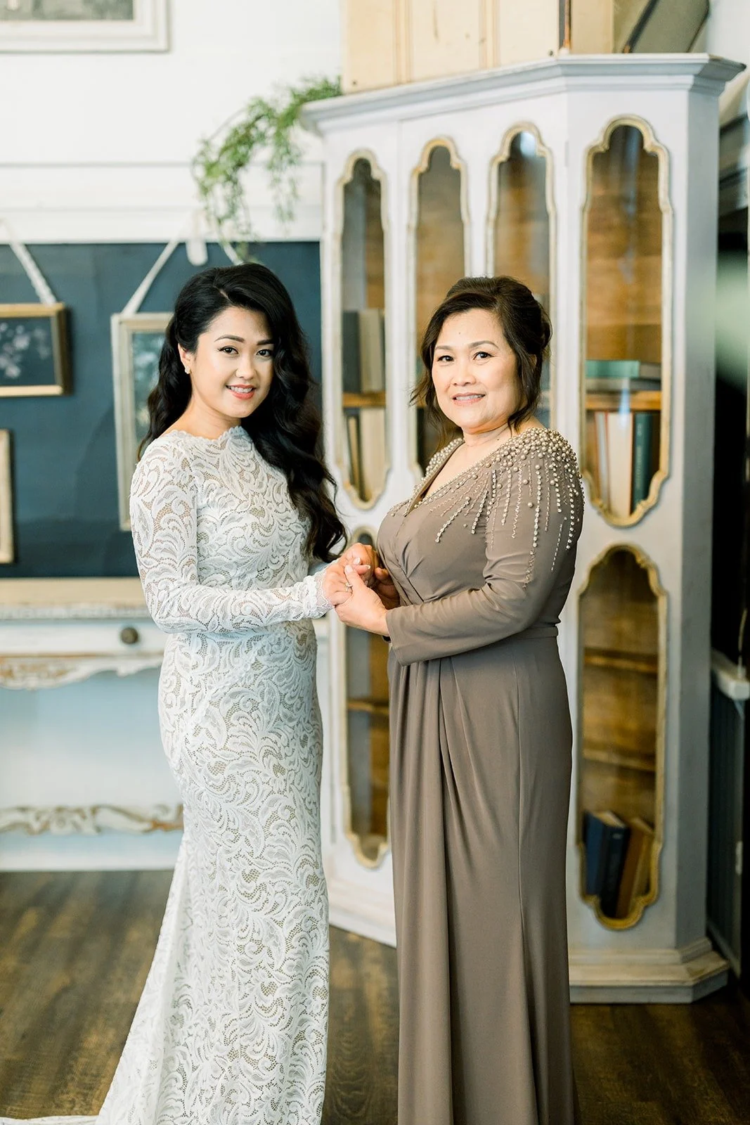 Hannah and her mom side by side in the bridal suite, photographed by One and Only Production