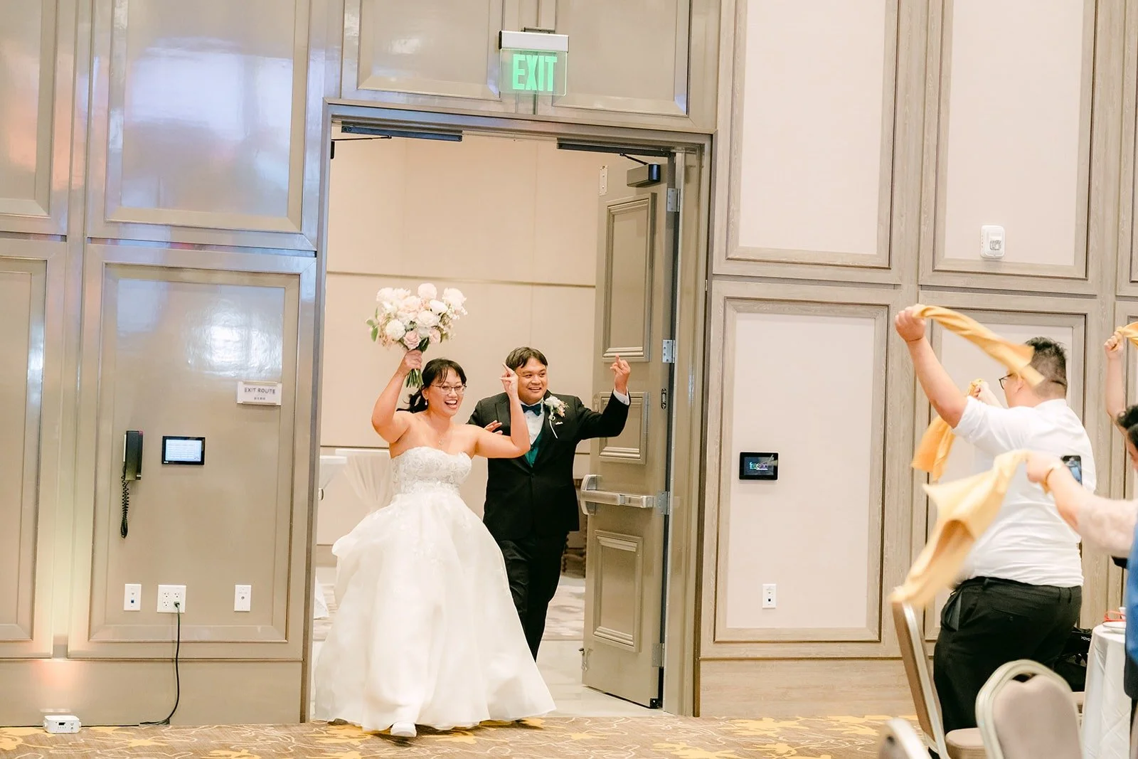 Stella and James making their entrance into the ballroom with their arms raised