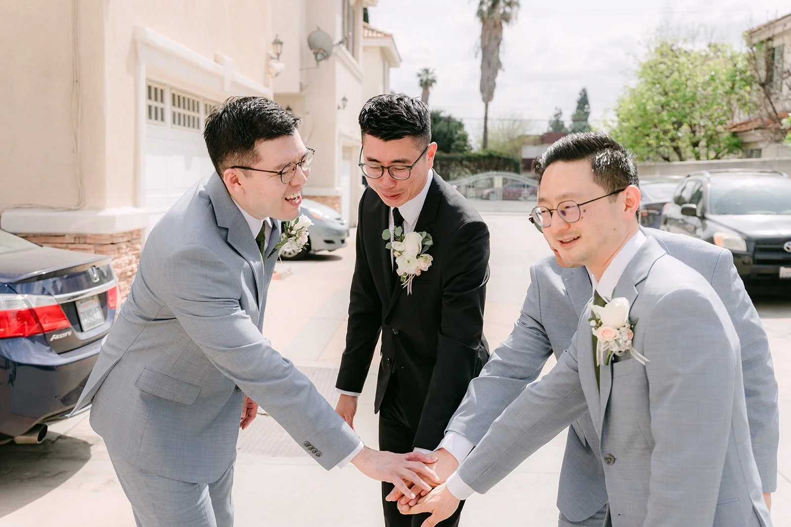 Eric and his groomsmen laughing as they walk up to the door