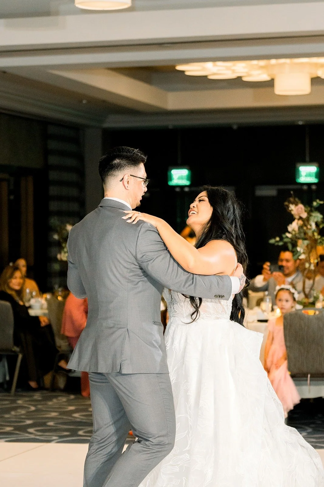Betsy and Mikey laugh during their first dance