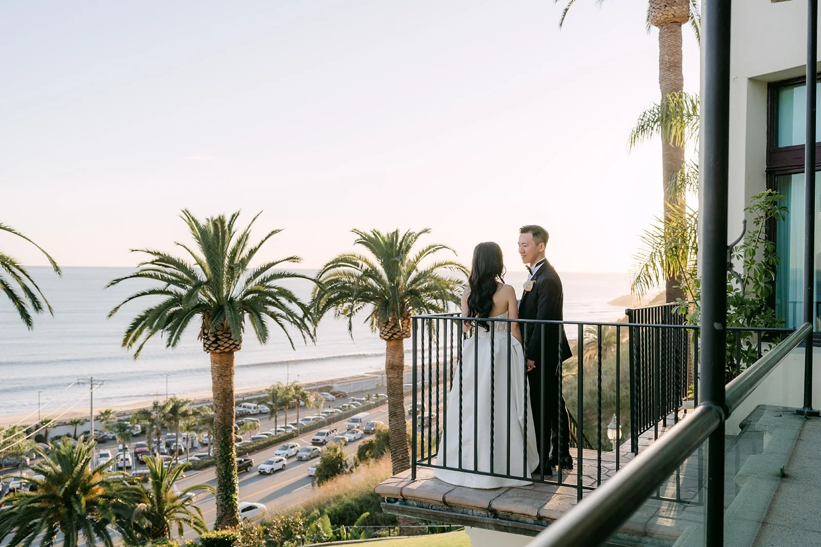 Couple on the balcony overlooking the coast at sunset