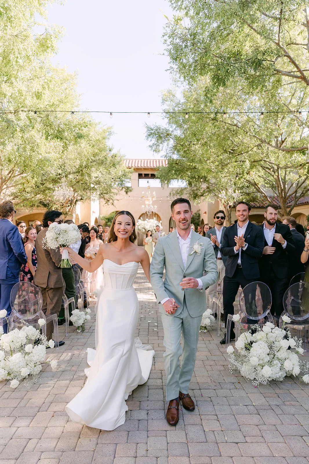 Kieu and Anthony walking back up the aisle as husband and wife