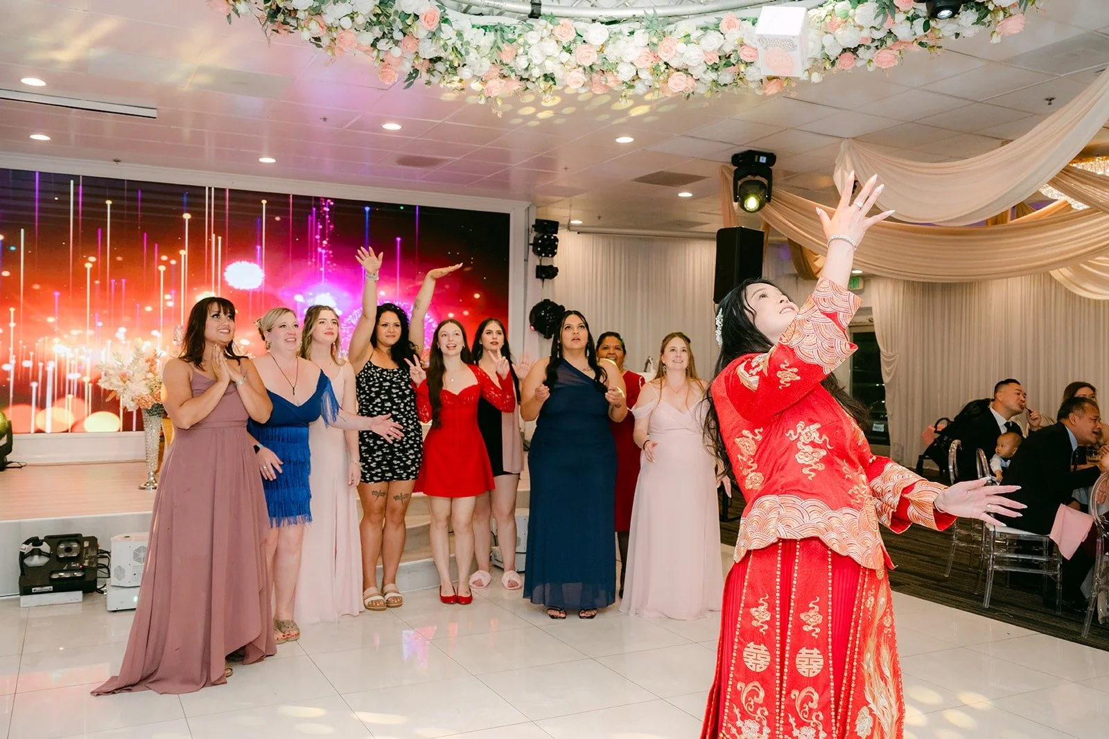 Guests gathering on the dance floor for the bouquet toss
