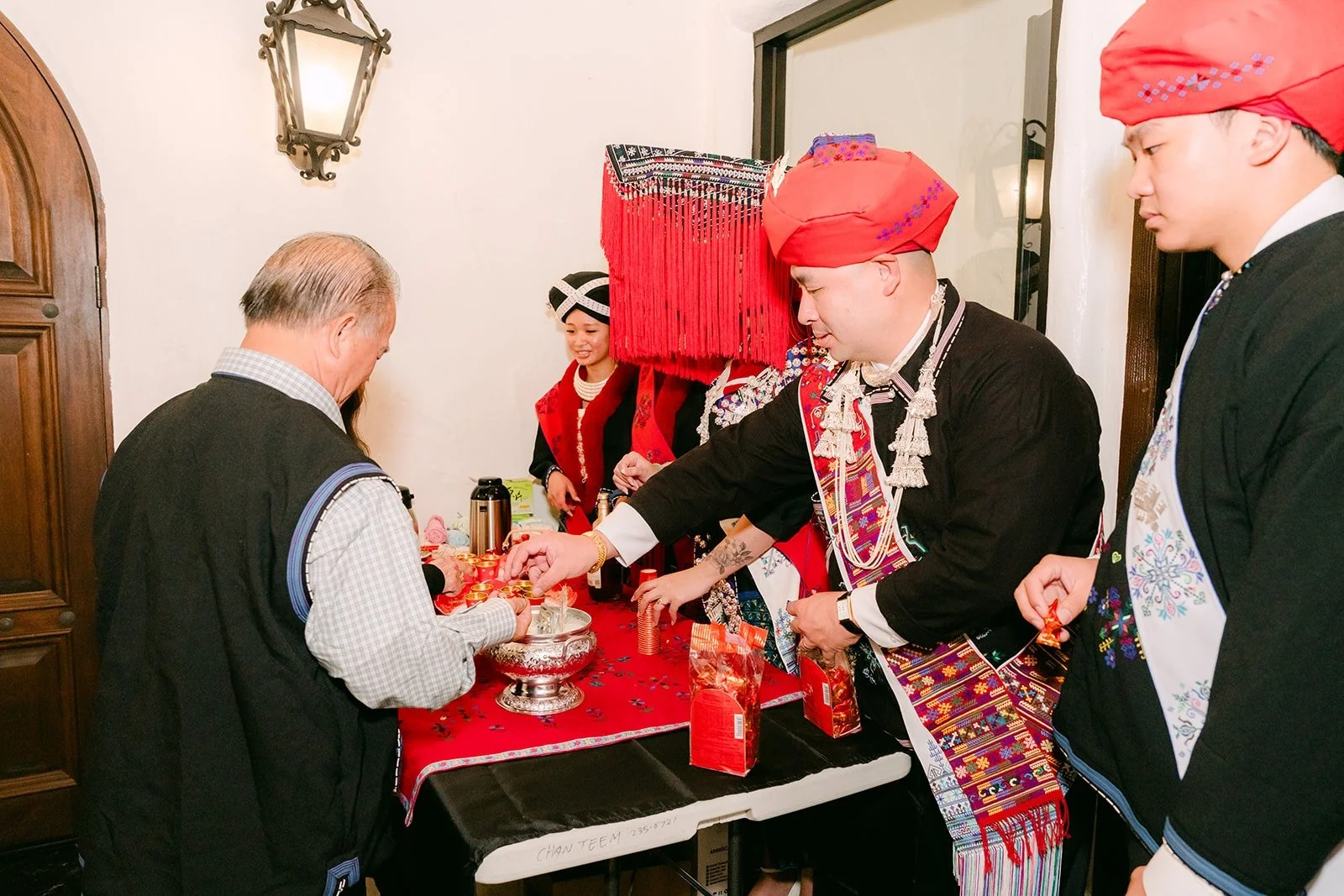Elders in red turbans at the Mien door greeting