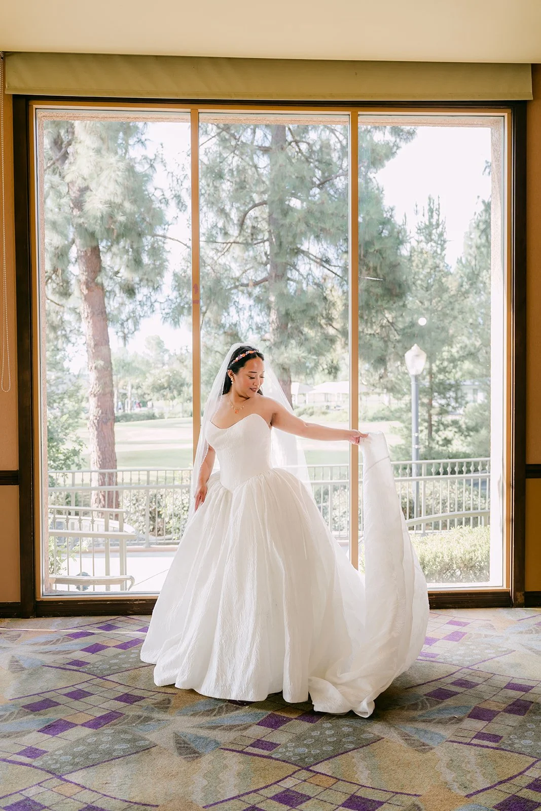Angela twirling her gown in the window light at Almansor Court