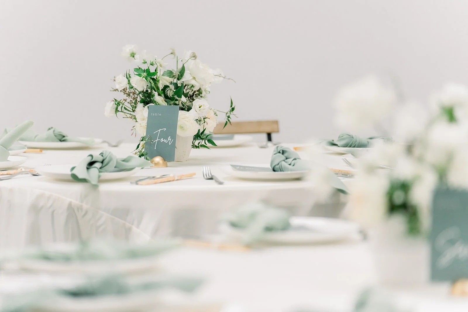 Reception tables set with white linens and florals