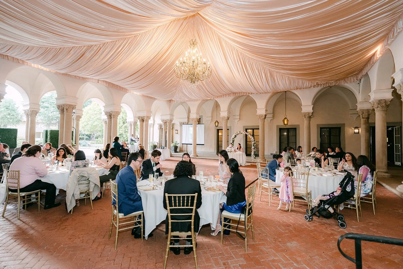 Guests seated for dinner on the West Patio