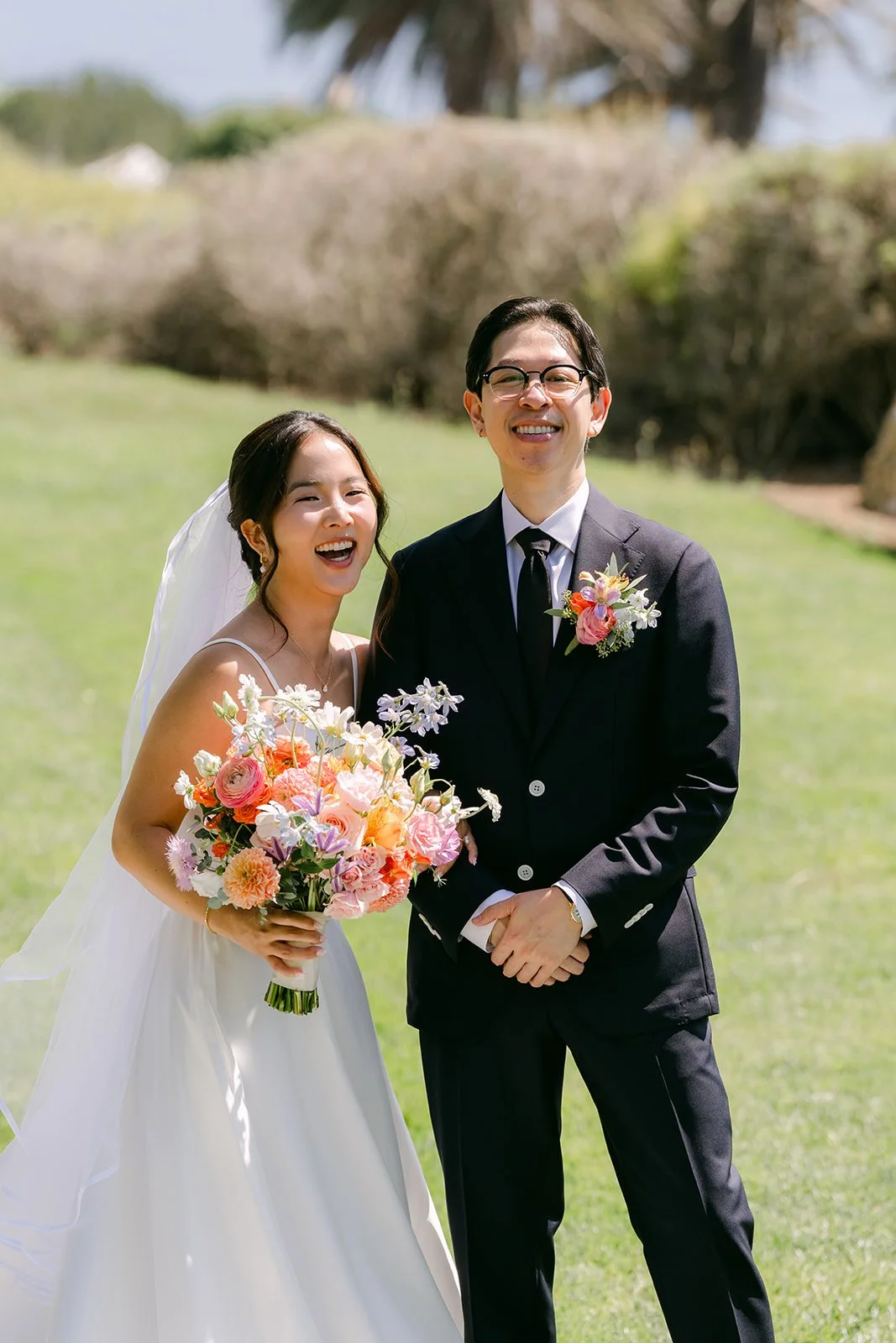 Saya and Leroy smiling with her colorful spring bouquet