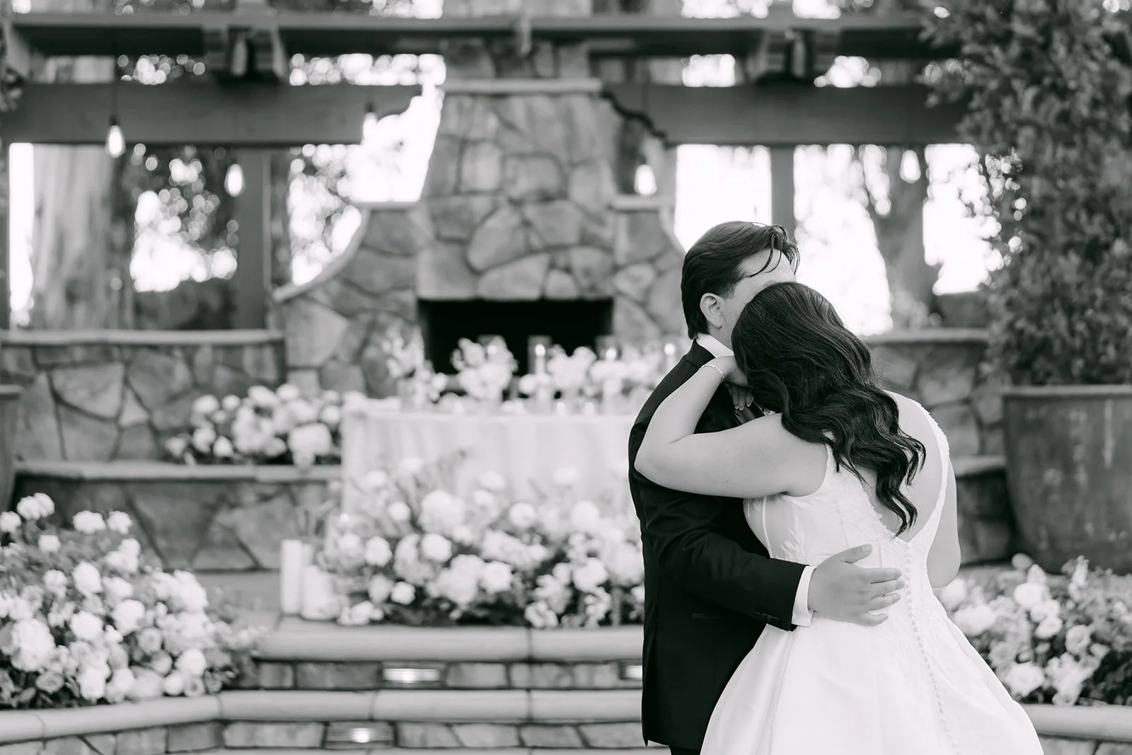 Black and white photo of the first dance by the fireplace