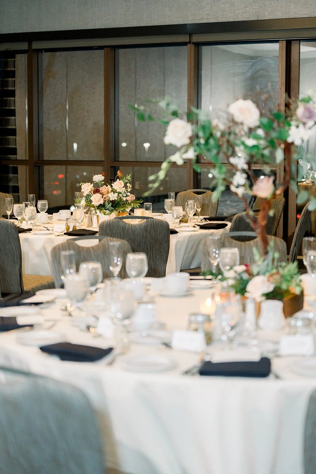 Tall white and blush centerpieces on the reception tables