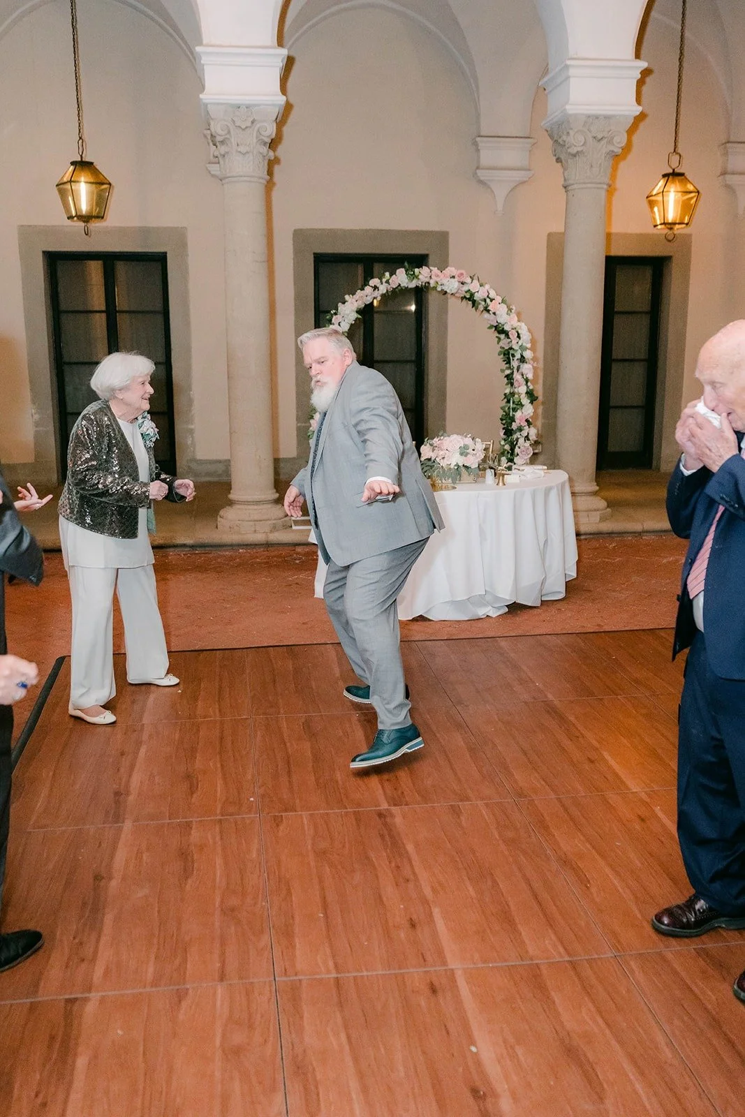 Guests dancing on the wood floor of the West Patio
