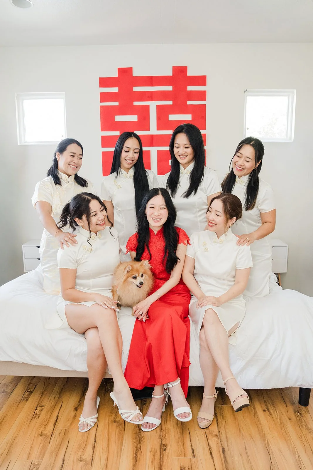 Valerie and her bridesmaids under a double happiness sign.