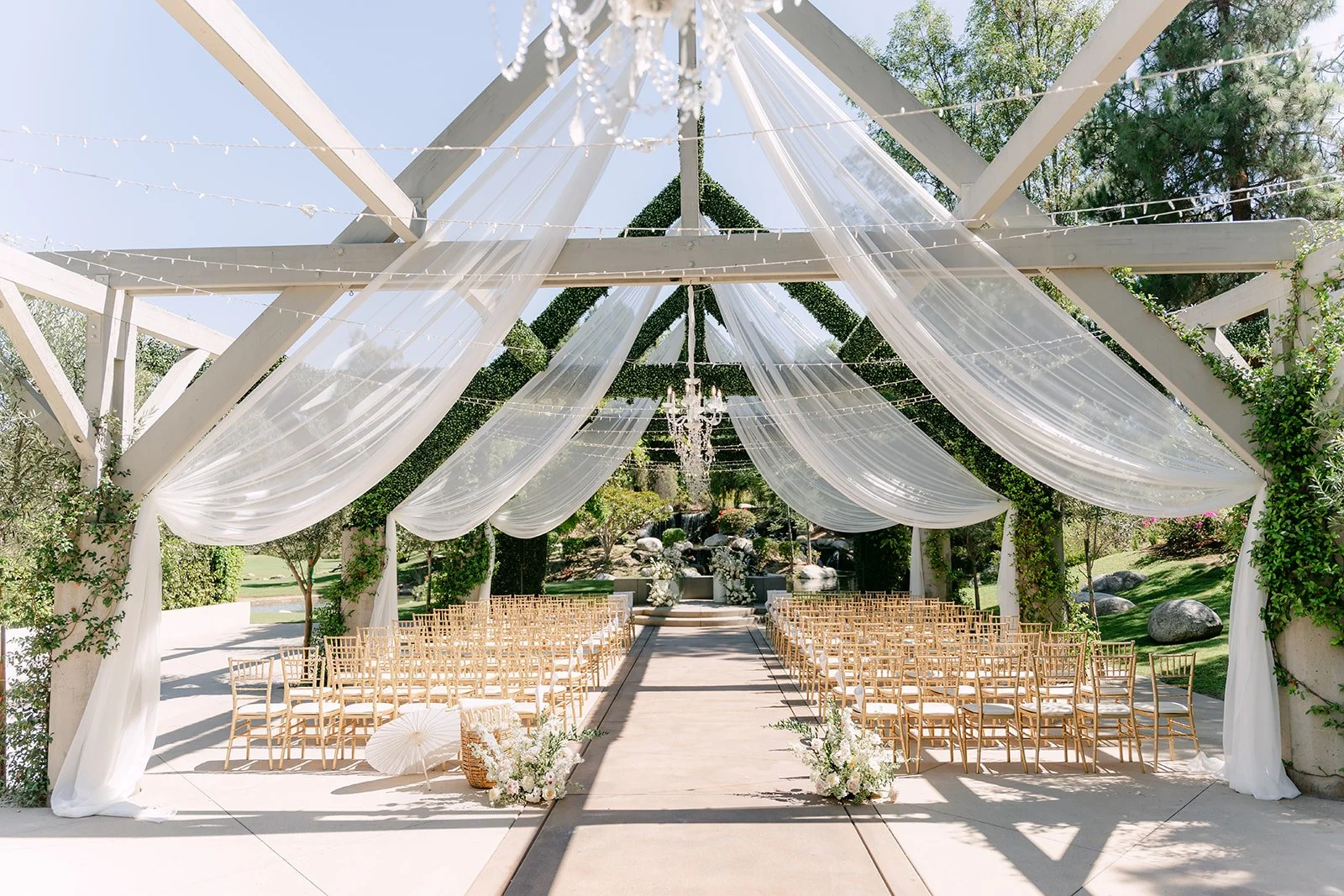 The draped white ceremony pergola and aisle at Coyote Hills Golf Course.
