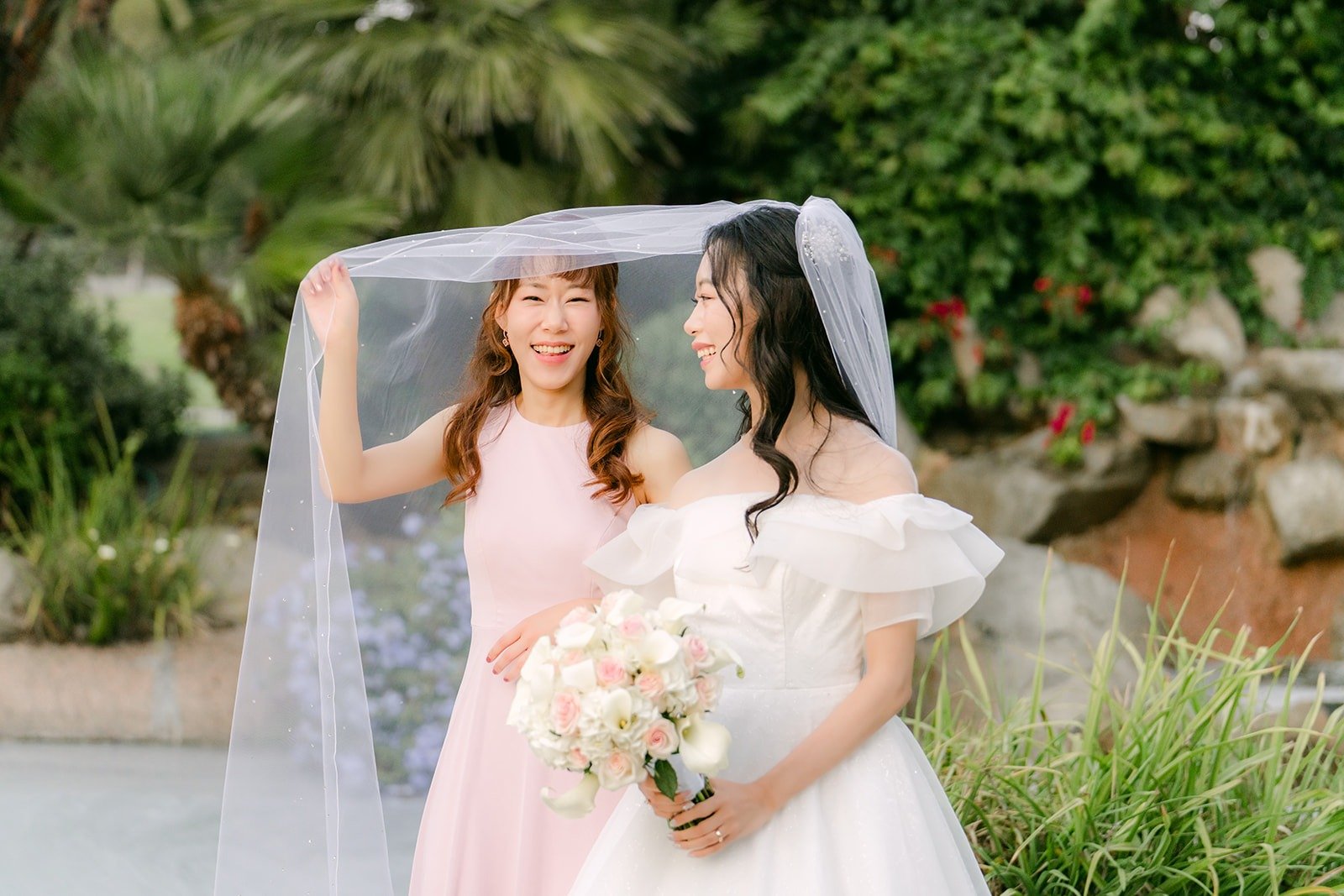 Jeannie and Stephanie laughing under the veil