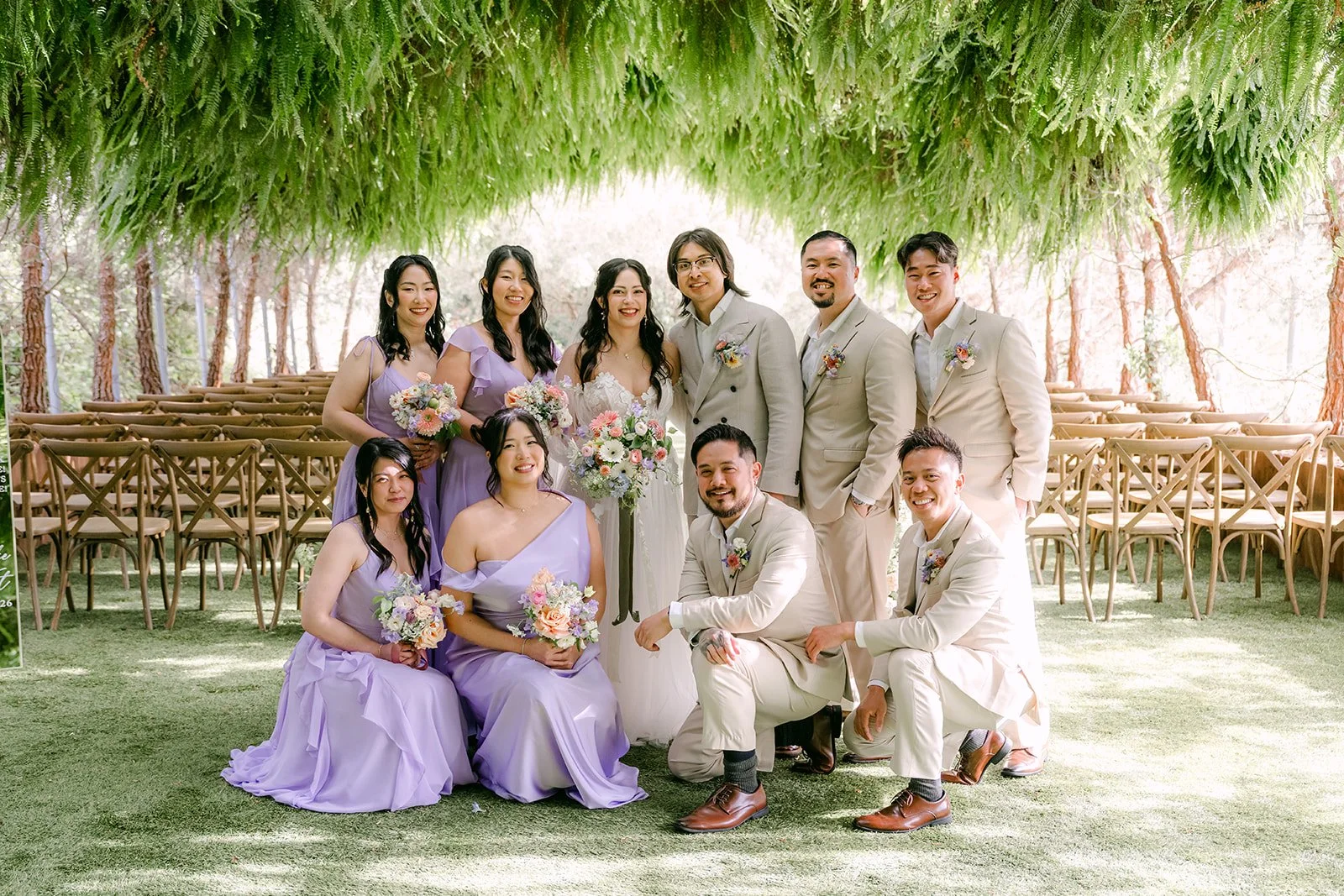 Wedding party posing under the fern canopy of the grotto