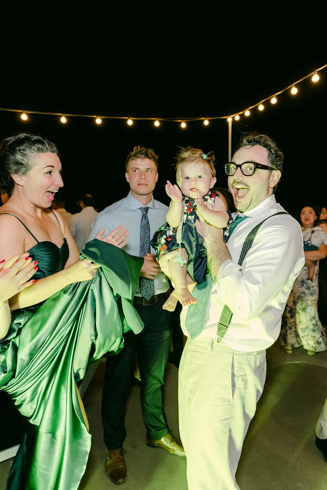 Guests dancing under colorful lights