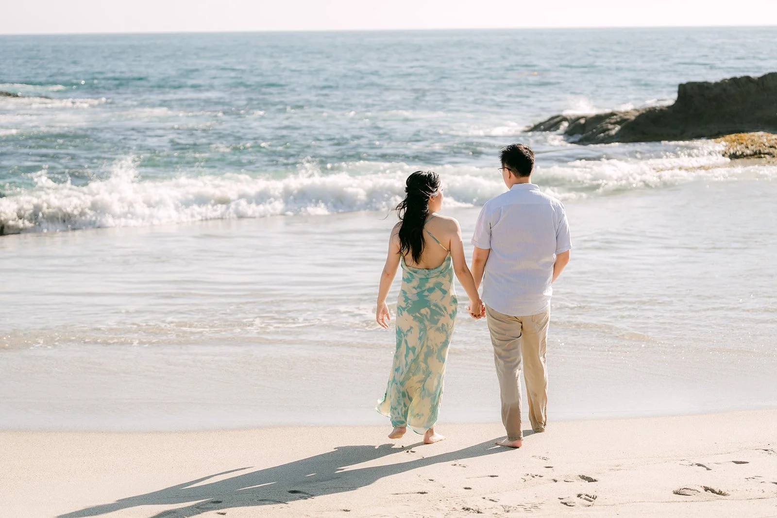 Constance and Lawrence walking toward the waves.