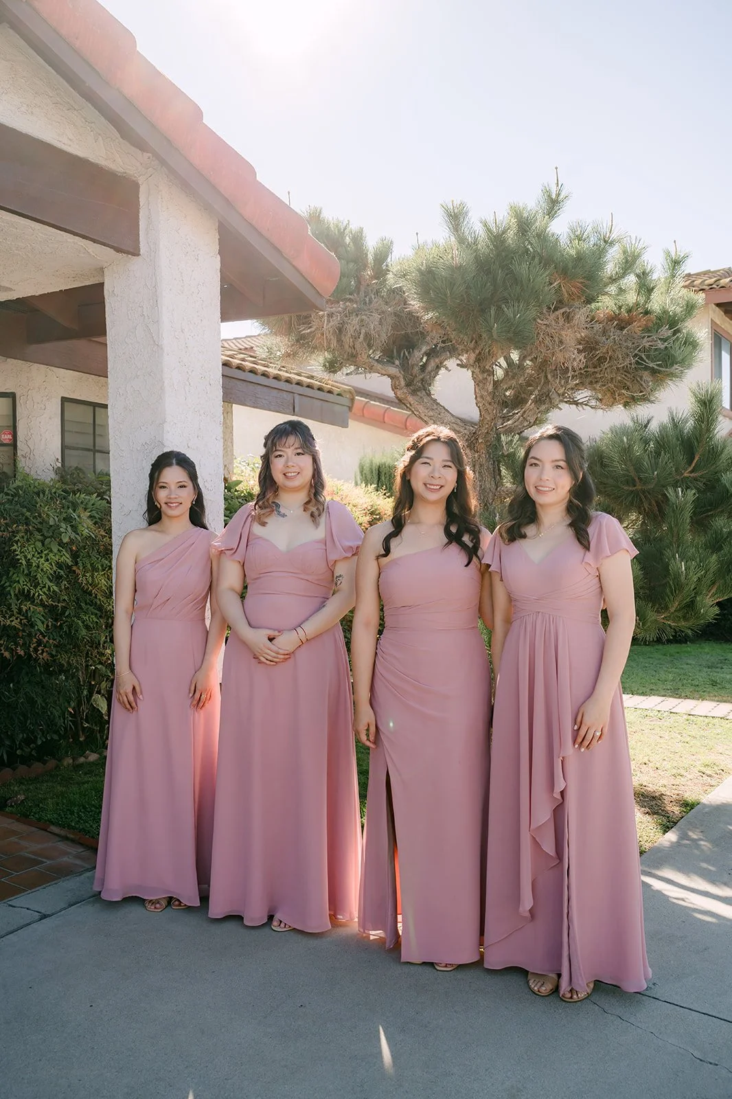 Pauline's bridesmaids in pink lined up outside.