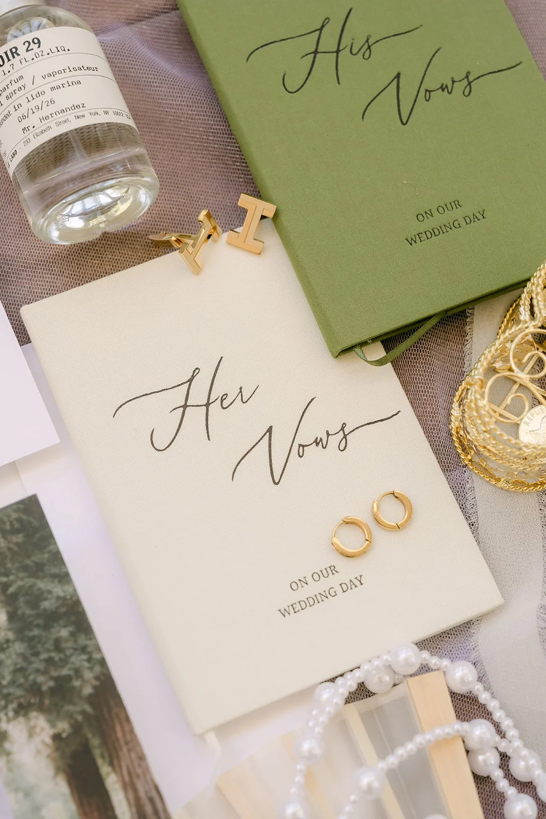 Vow books and wedding bands styled with Nicole's perfume for her Eden Gardens wedding.