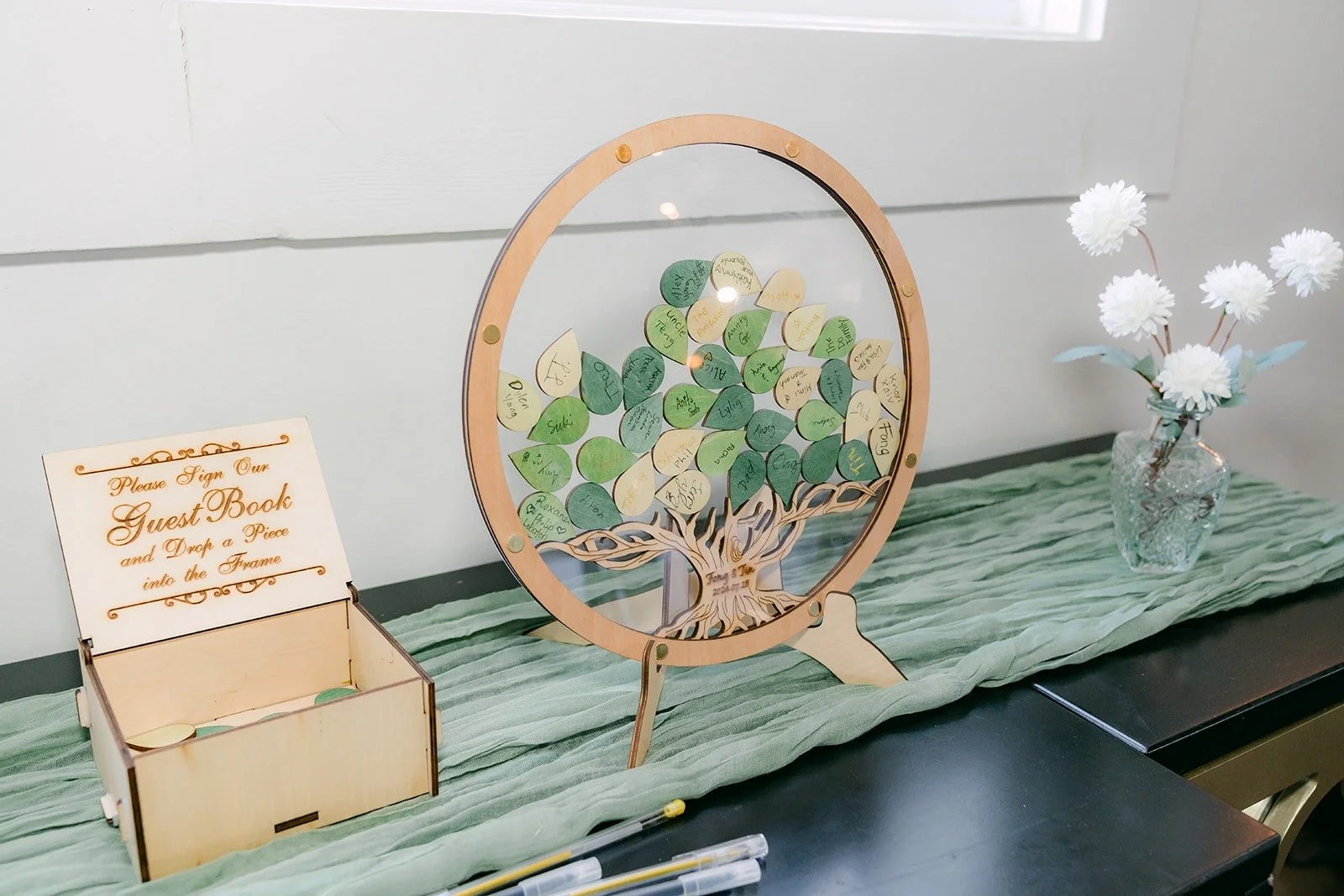 A round floral hoop and card box on the gift table, photographed by One and Only Production