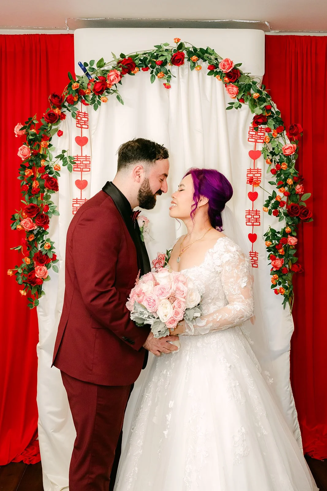 Vanessa and Ryan nose to nose under the arch.