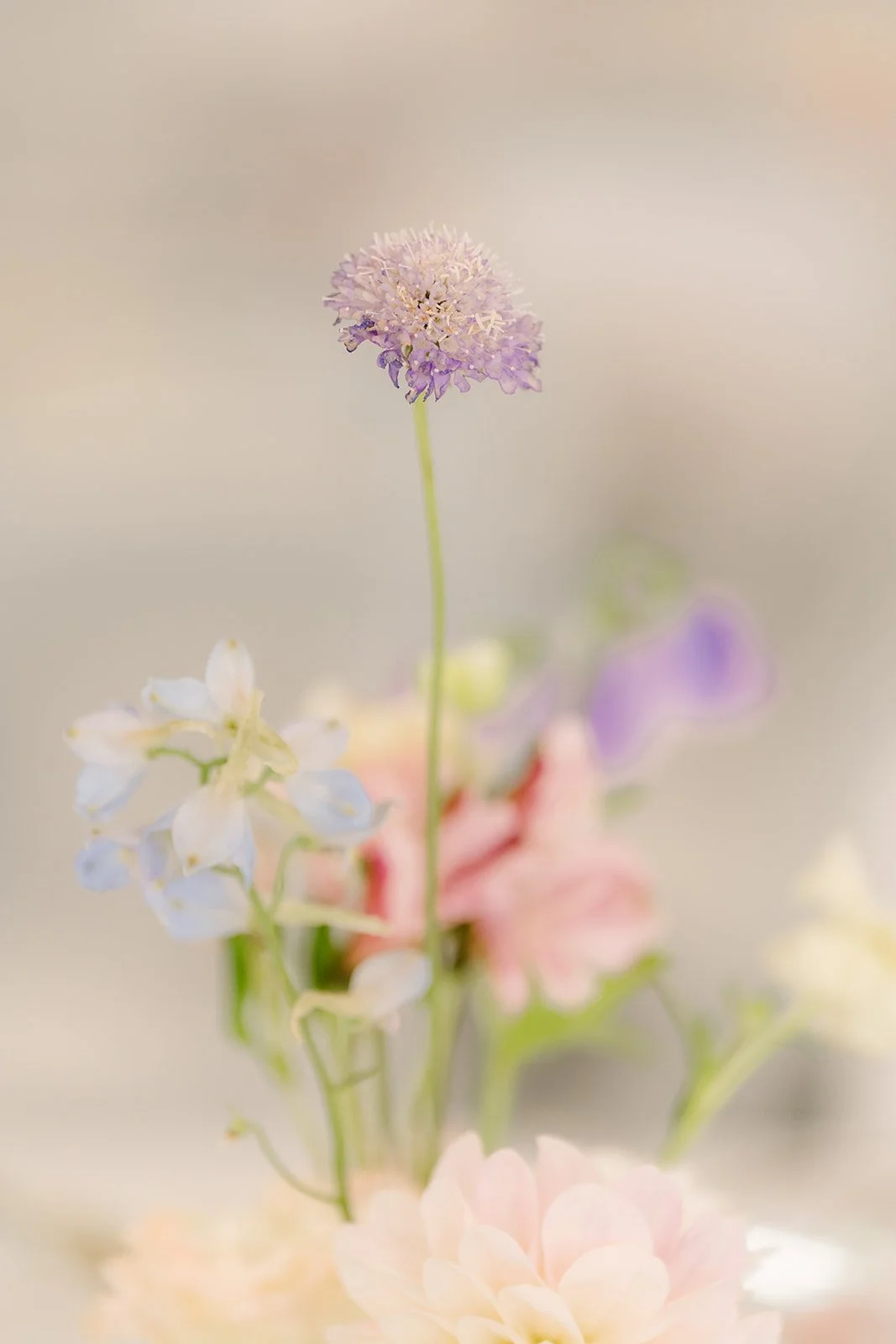 Delicate pastel bud vase florals on a reception table.