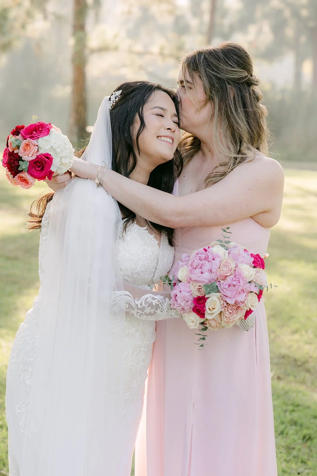 A bridesmaid kissing Amy on the cheek