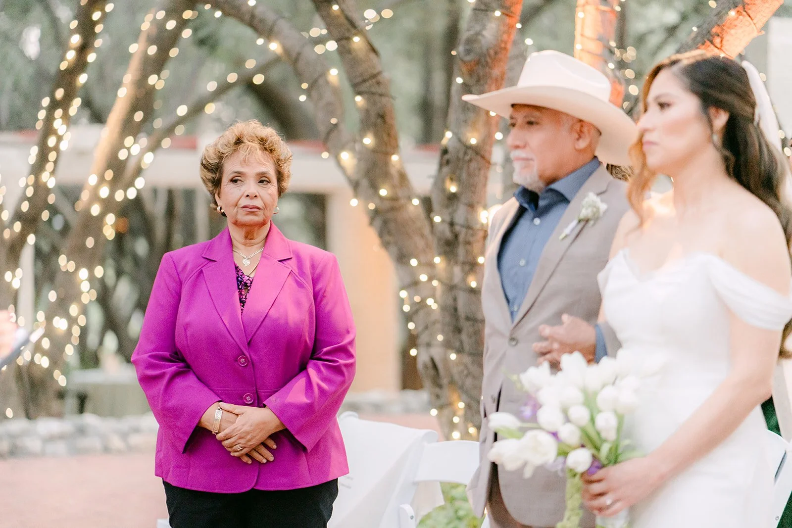 Mariana's dad bringing her to the gazebo as Danny's mom looks on