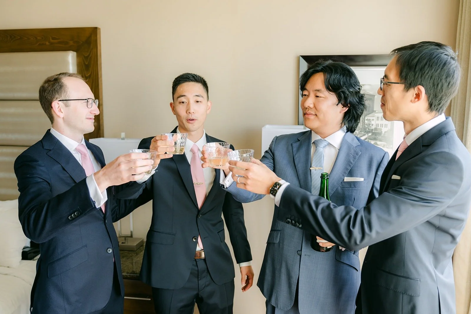 Philip and his groomsmen laughing together in the hotel room