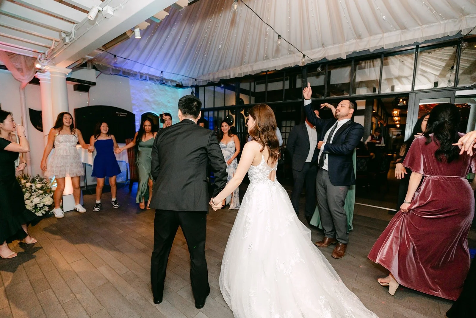 Valerie and Jason dancing in the middle of their guests
