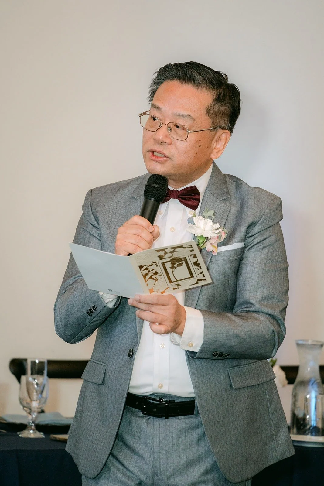 A guest reads his toast from a card