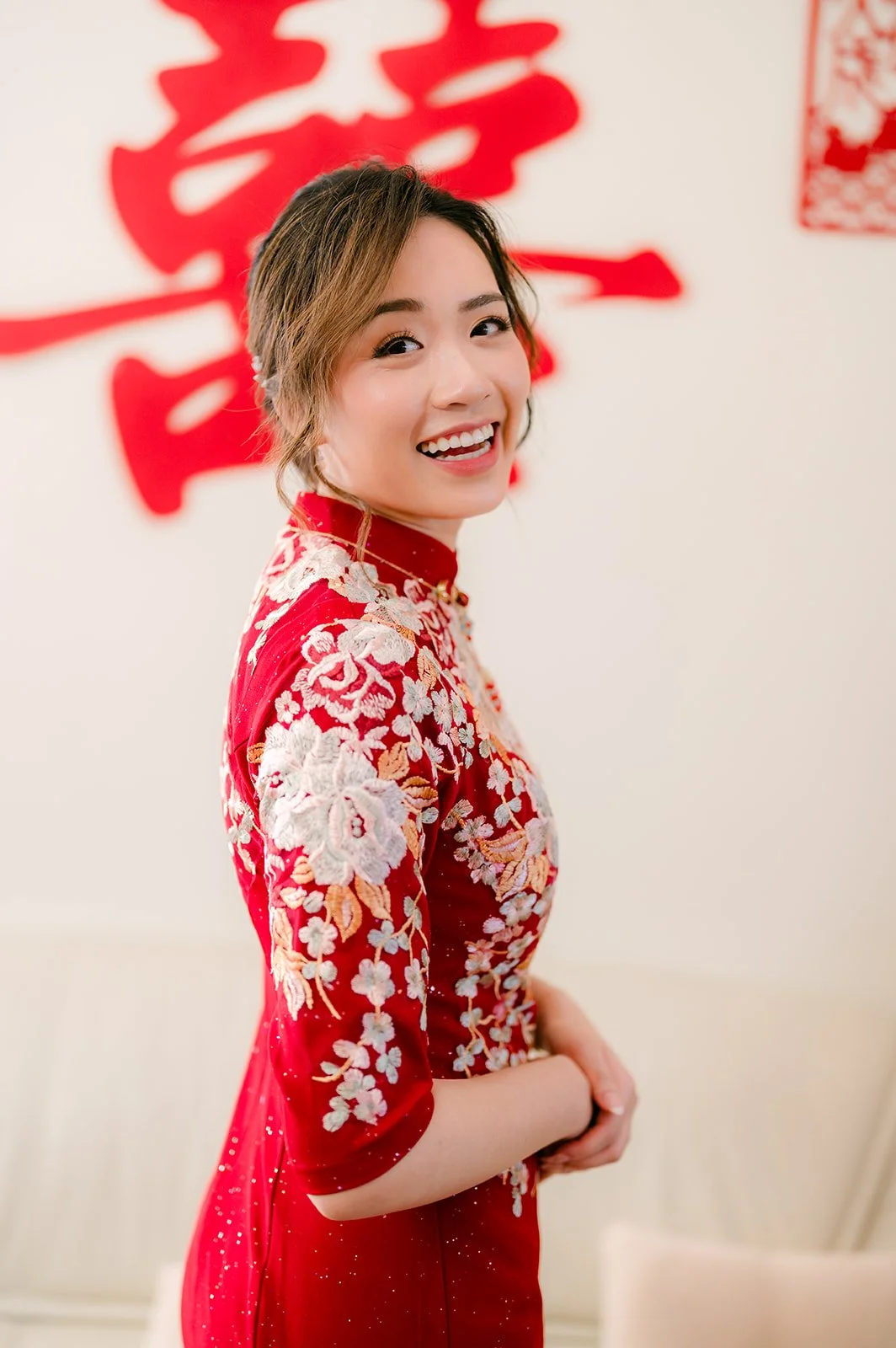 Pauline smiling in her qipao.