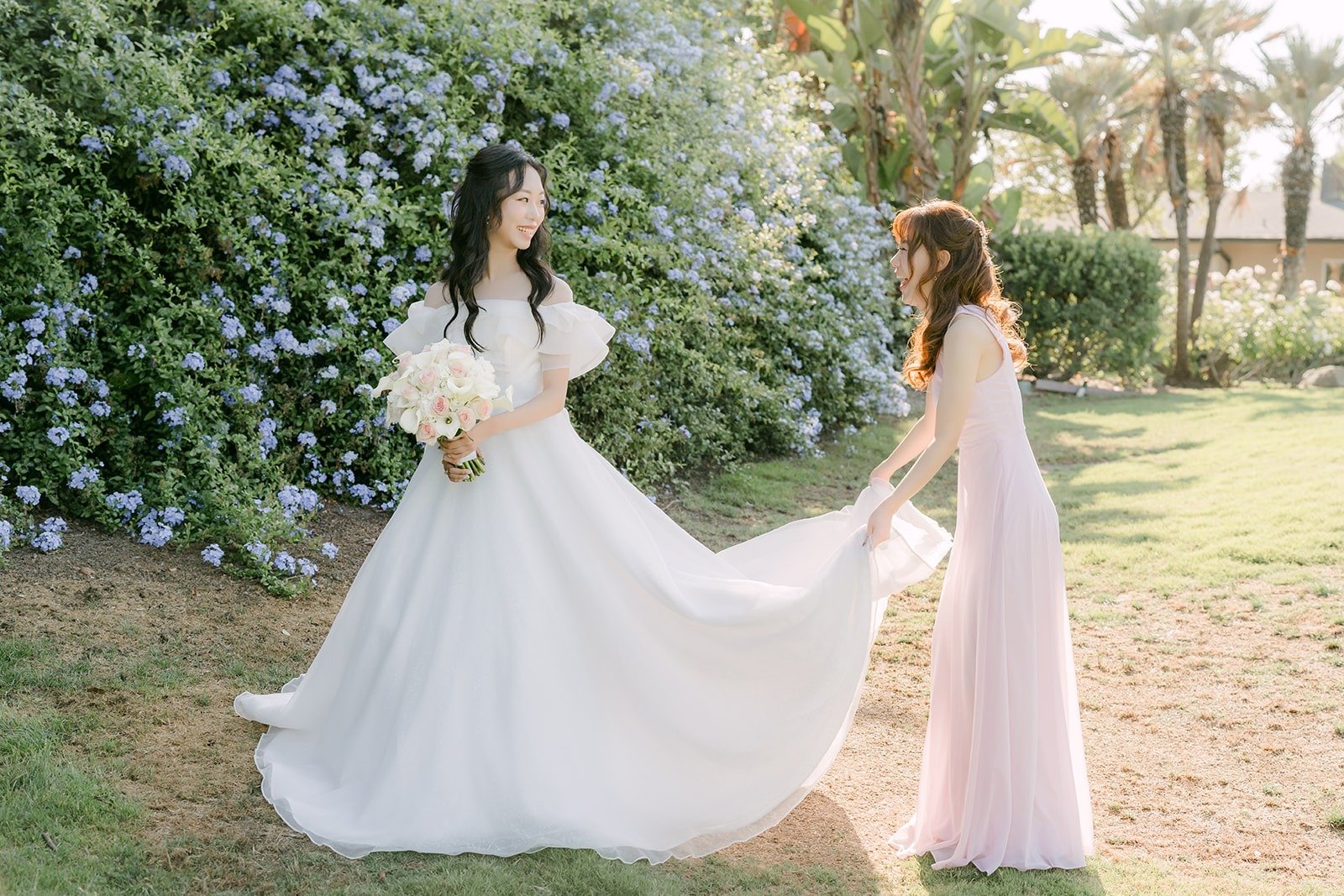 Jeannie's sister and maid of honor Stephanie spreading out her train
