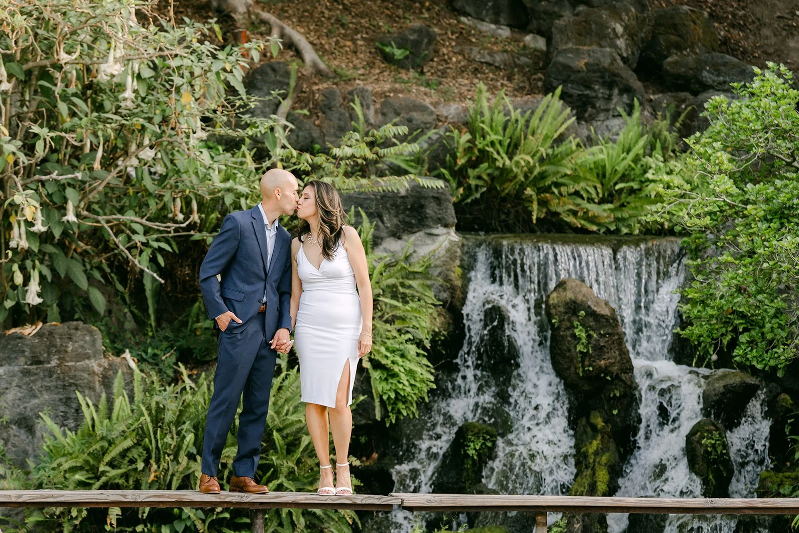 Francesca and Daniel pose beside the cascading waterfall.