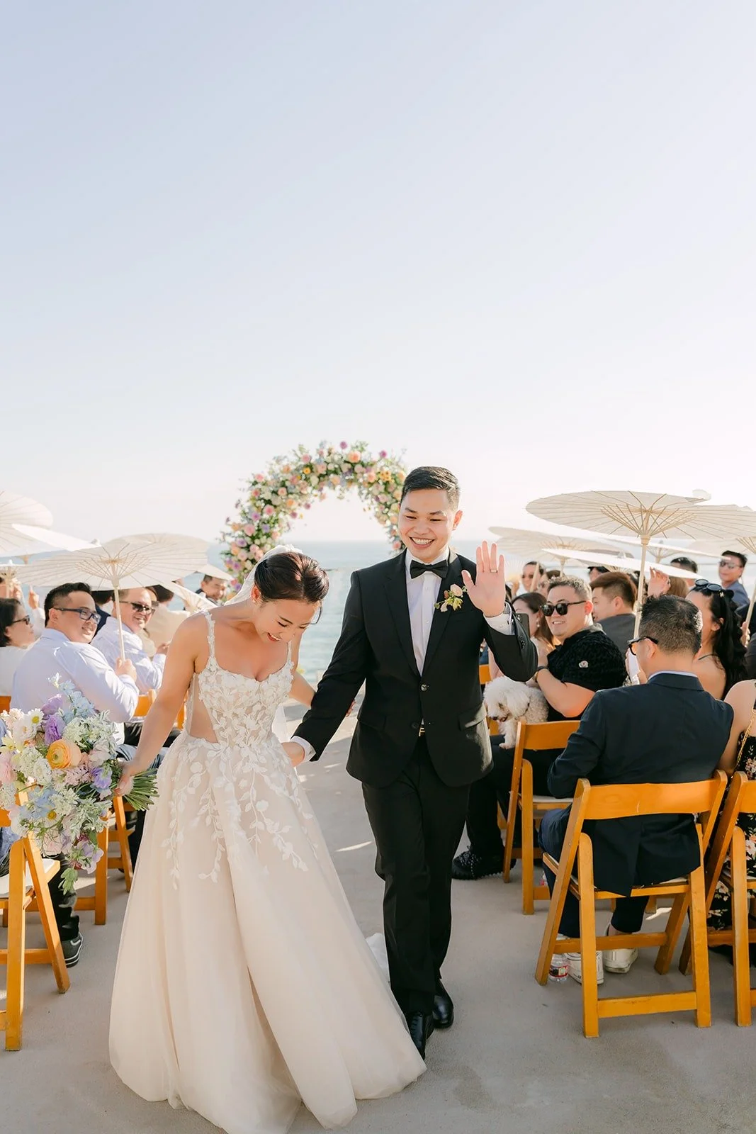 Kylie and Mario walking back up the aisle as guests cheer, photographed by One and Only Production