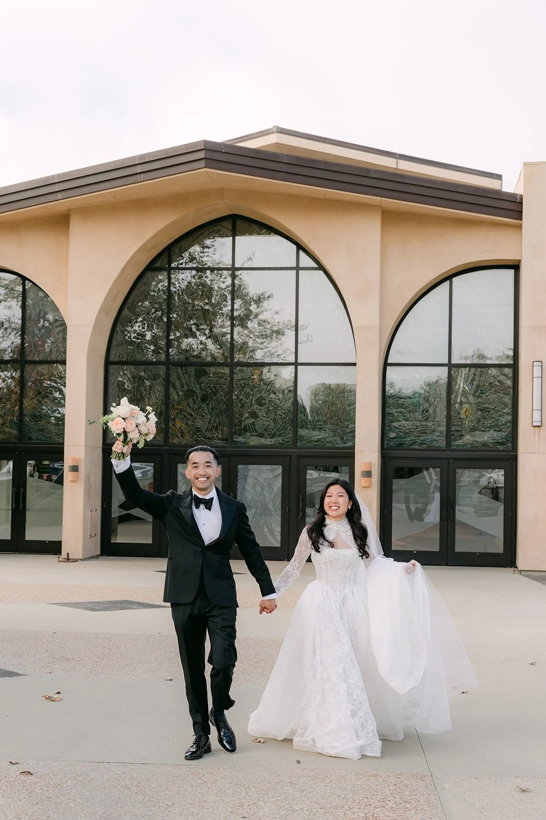 Kim and Vincent walking in front of the church arches
