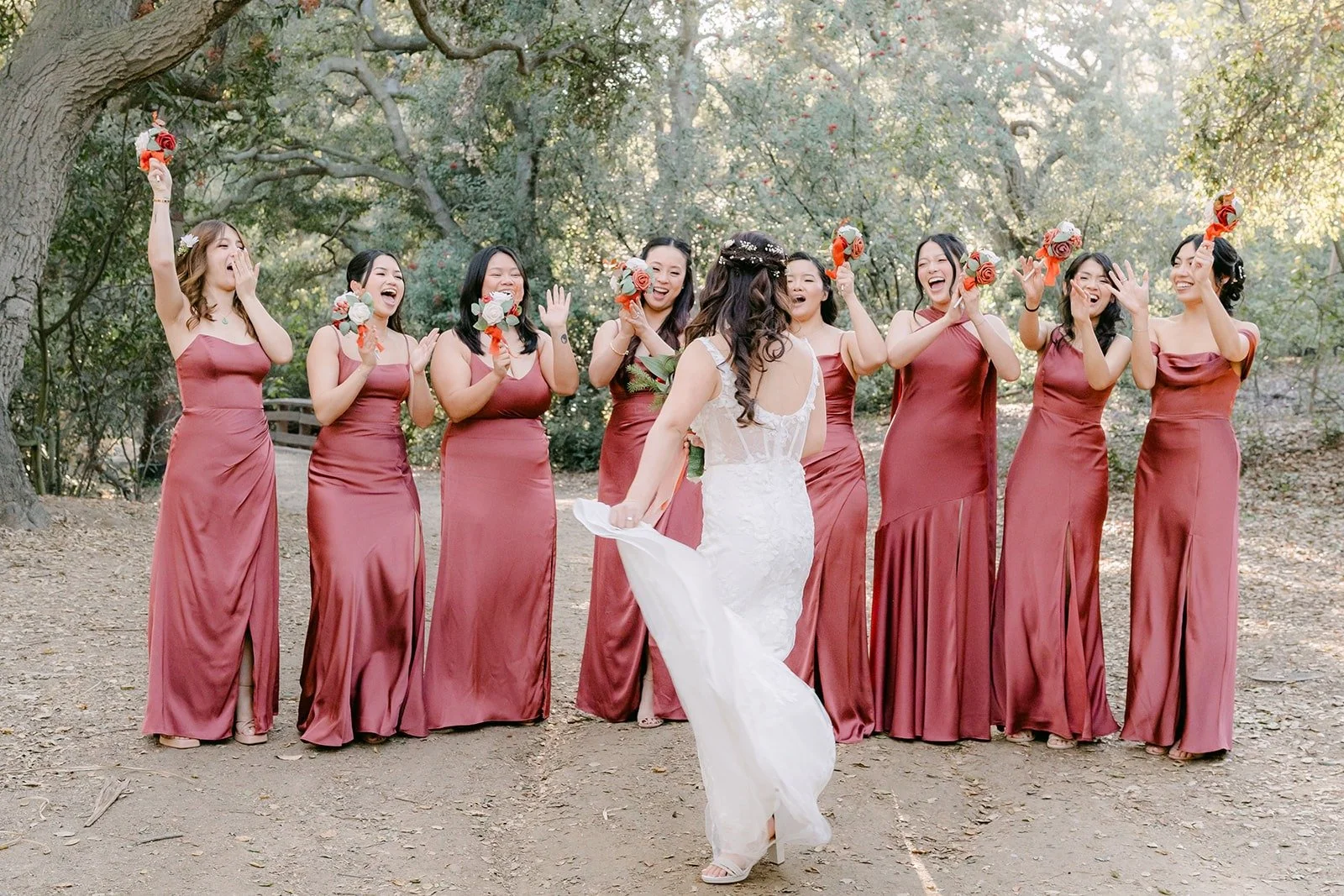 Shayna lifts her dress as her bridesmaids celebrate behind her