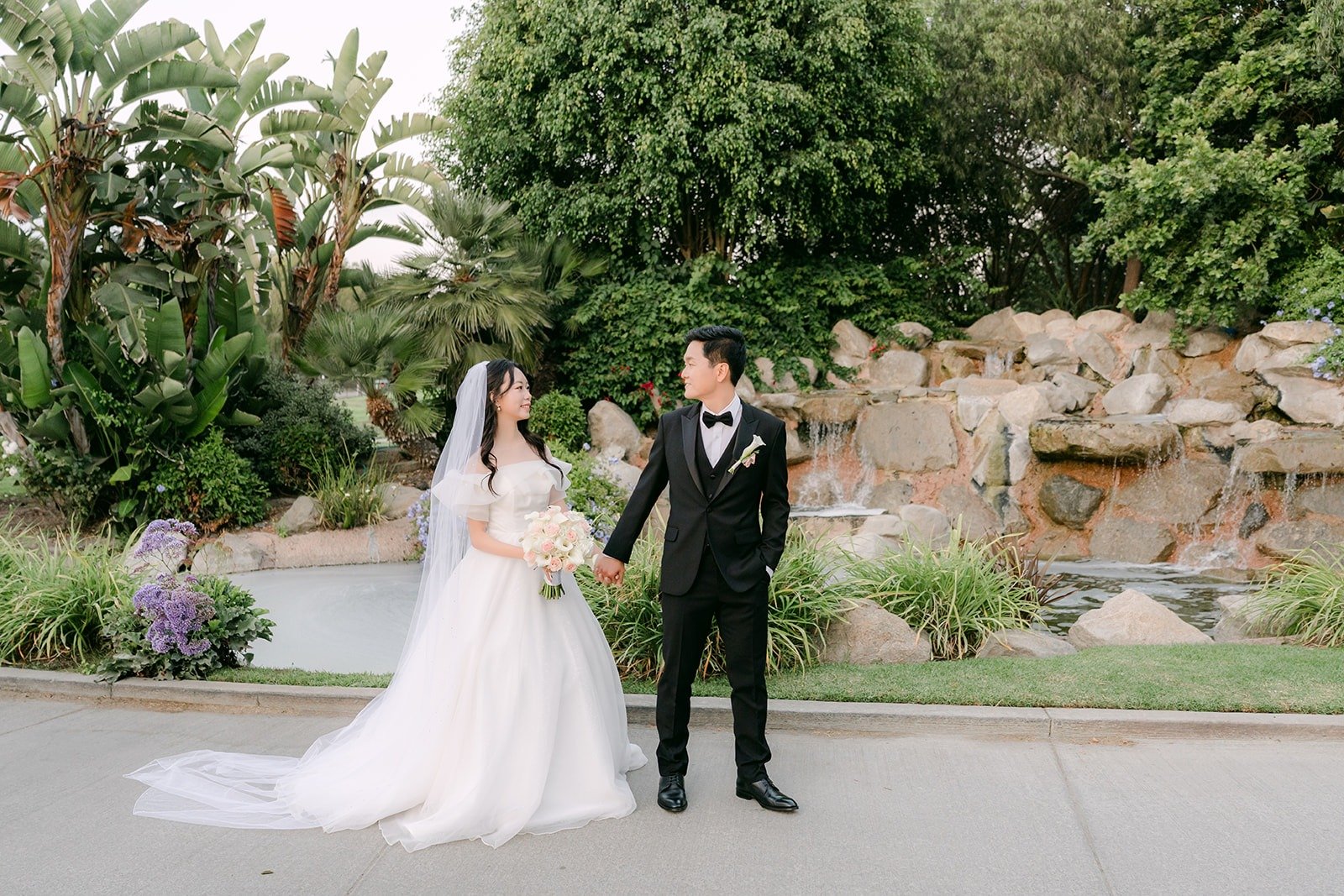 A wider view of Jeannie and Eunsang by the waterfall