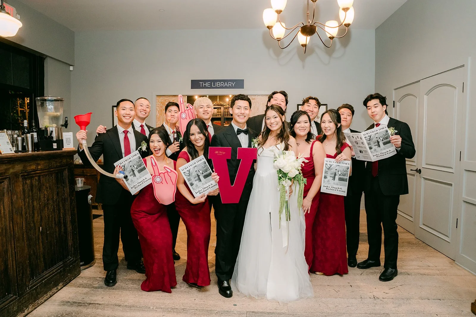 Wedding party holding signs before the grand entrance