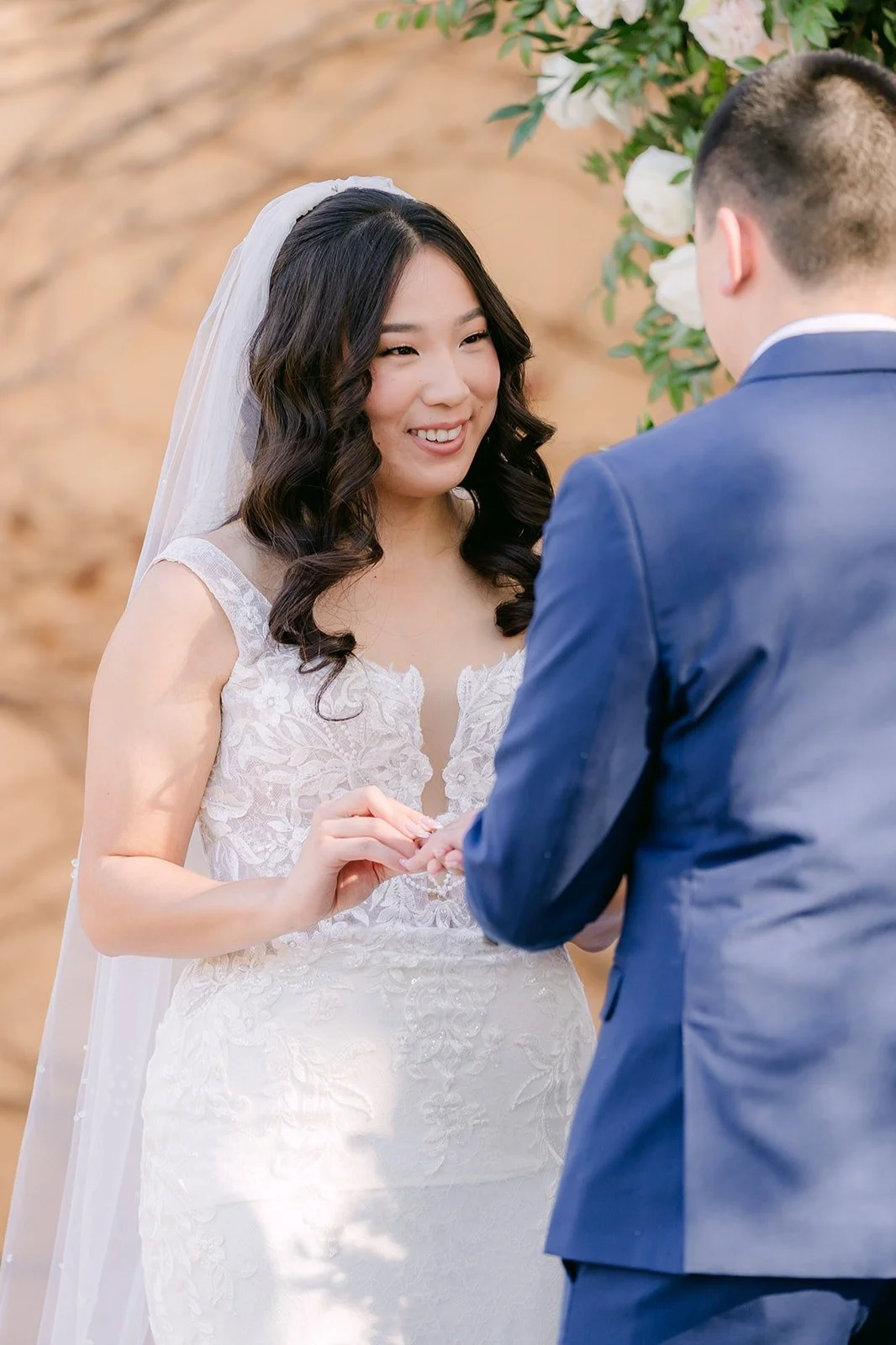 Kelli smiling at Alex during the ceremony