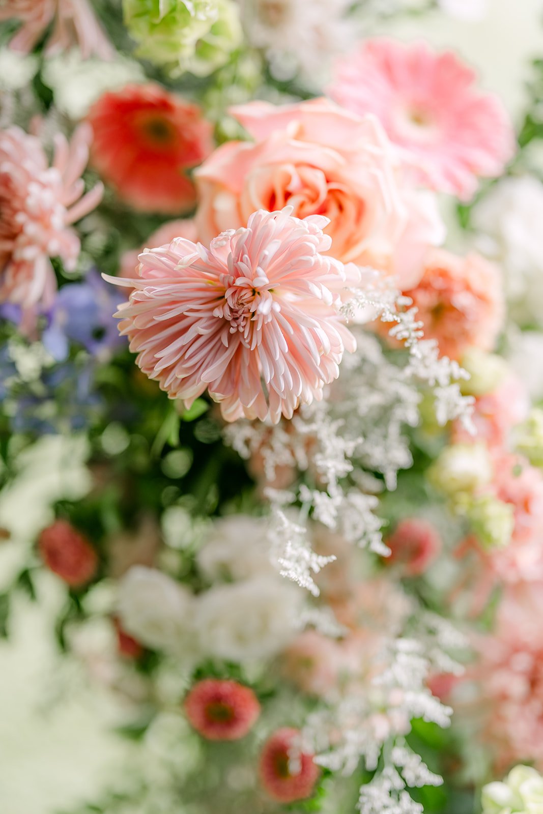 Close up of peach dahlias and pastel ceremony flowers