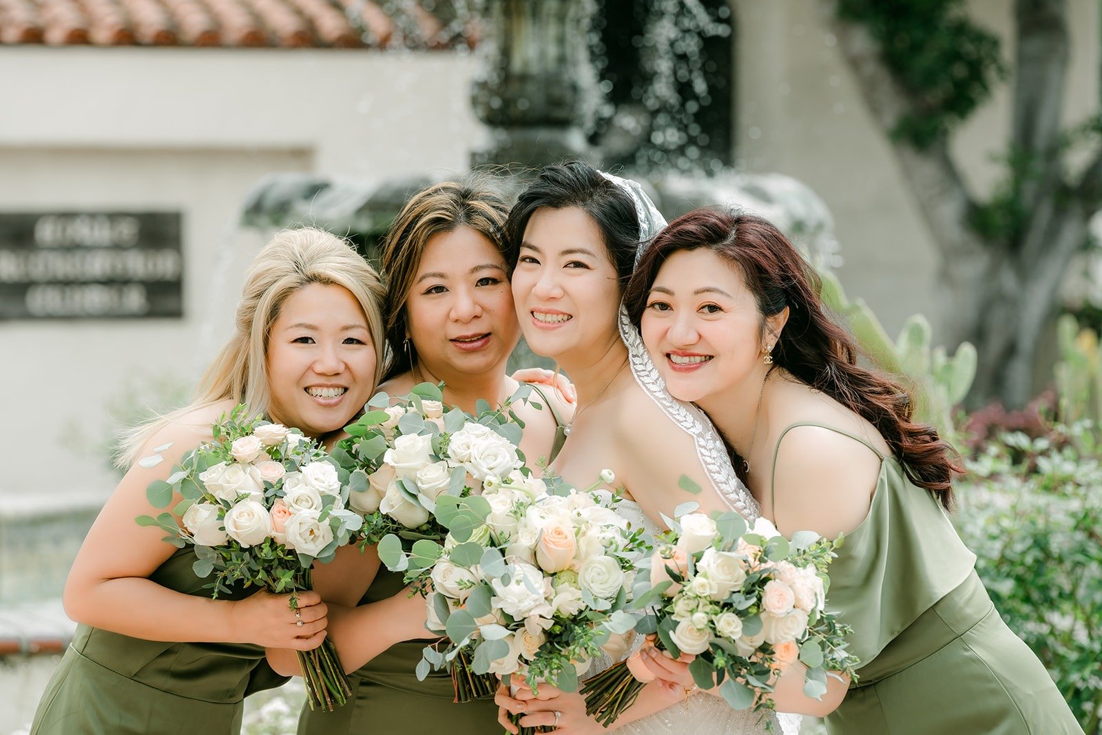 Eunice and her bridesmaids squeeze in together with their bouquets